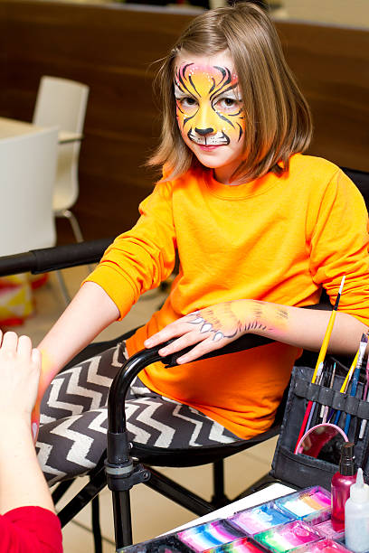 istock Girl getting her hands and face painted 471745840