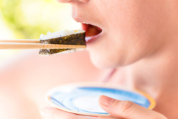 young woman eating sushi