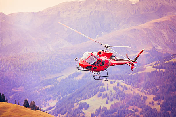 istock Red helicopter landing in Alpine Switzerland 471746677