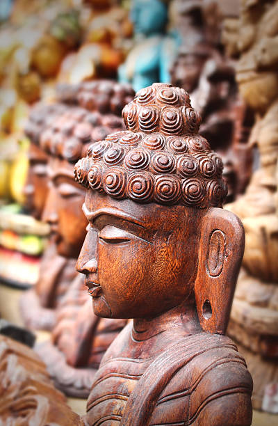 Wooden statue or idol of lord Buddha meditating stock photo