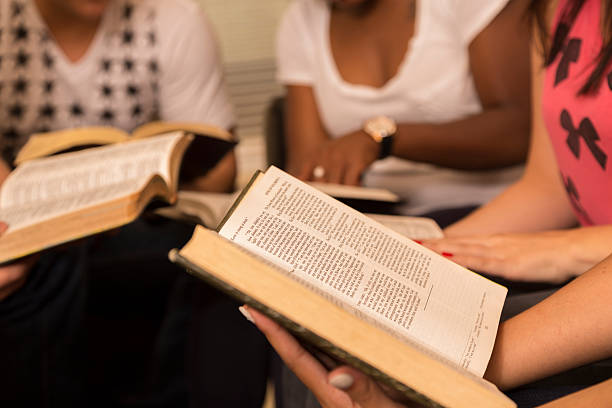 istock Spirituality: Group of young adults gather for Bible study. 471747415