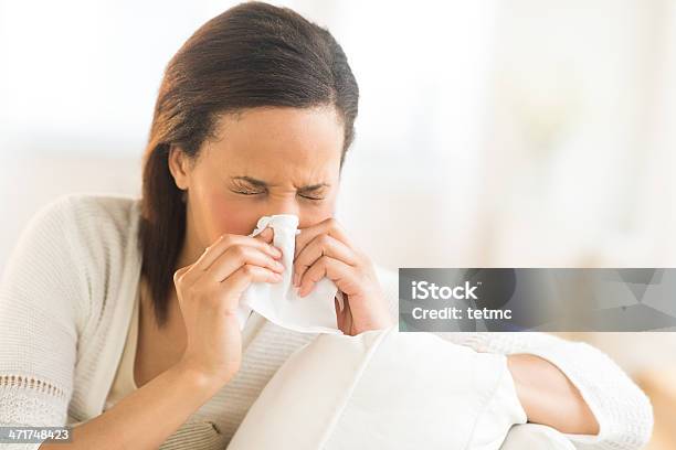 Woman Blowing Nose With Tissue At Home Stock Photo - Download Image Now - 20-29 Years, 25-29 Years, Adult