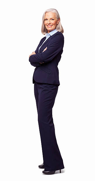 Full length portrait of confident senior female business entrepreneur standing arms crossed. Vertical shot. Isolated on white.
