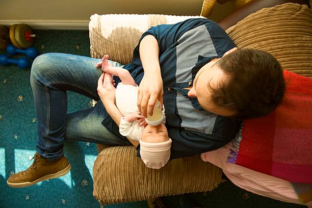 istock sporting modern father breastfeeding newborn from above 471750160