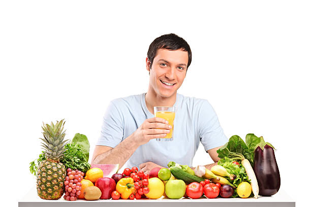 Handsome guy with glass of juice, on a table