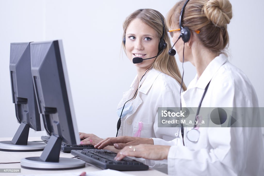 Online medicine support Female doctor and nurse talking in a callcenter 40-49 Years Stock Photo