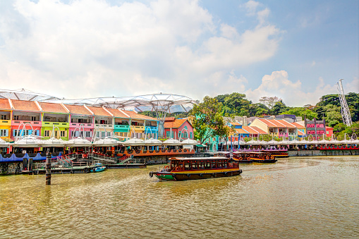 Colorful bars and restaurants dot the Singapore River along Clarke Quay. The area used to be a commercial center during the colonial era where warehouses are located. Now, it is converted into a popular meeting place for locals and tourists alike. HDR rendering.