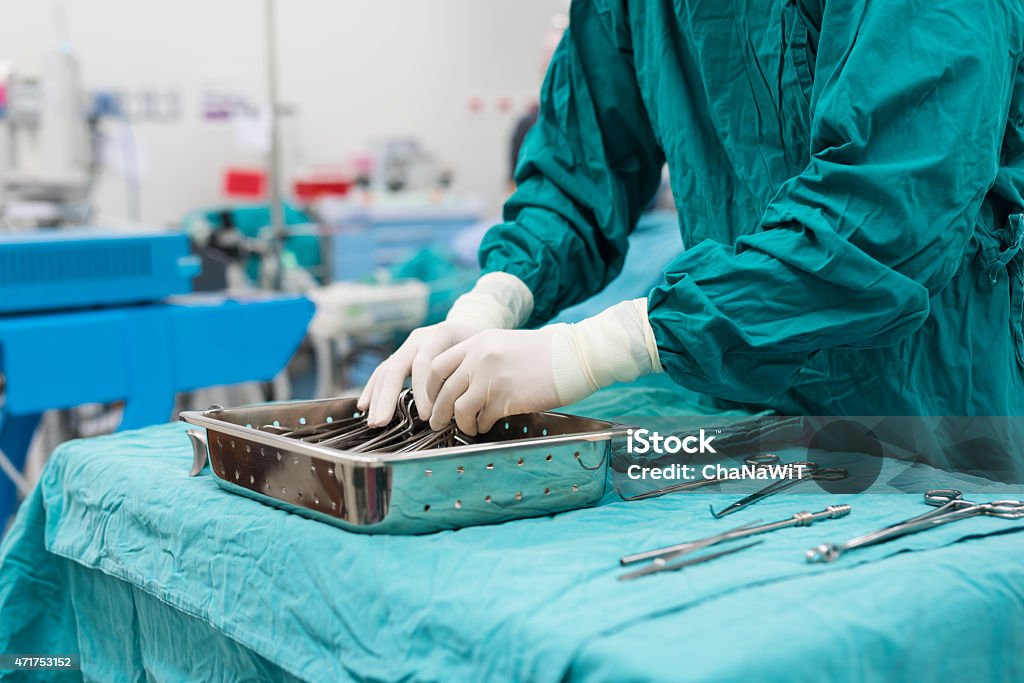 scrub nurse preparing medical instruments for operation 2015 Stock Photo