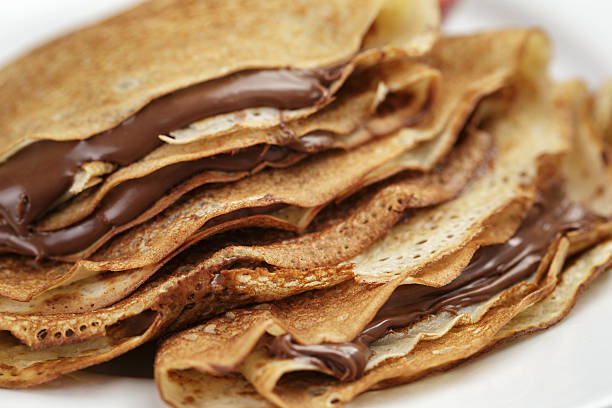 istock thin crepes or blinis with chocolate cream on plate 471753376