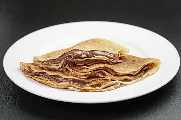 istock thin crepes or blinis with chocolate cream on plate 471753378