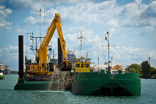 Heavy duty industrial equipment moving product from shipping barge.