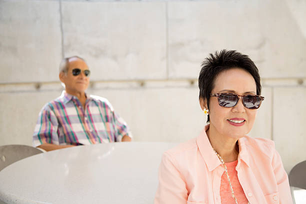 istock Senior Asian Woman Sitting with Her Husband 471754120