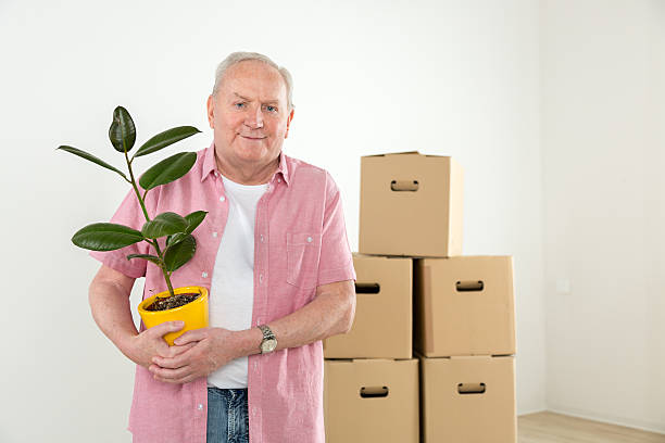 istock Relocation - smiling senior man moving house 471754146