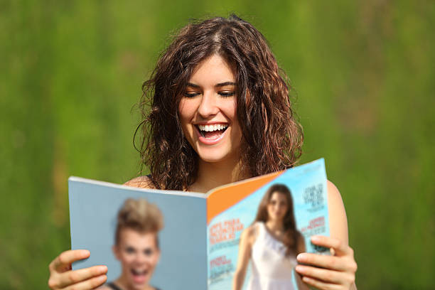 Happy woman reading a magazine