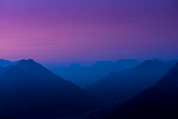 istock colored sky behind mountains at sunrise 471755075