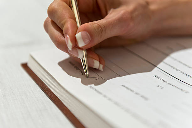 istock Woman hand signing contract 471755477