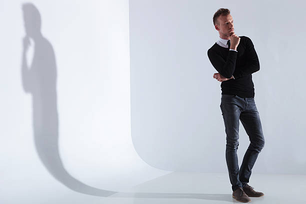istock pensive casual man looks away 471755633
