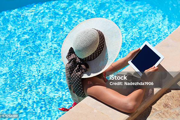 Young Woman With Touch Pad On Vacation Stock Photo - Download Image Now - Digital Tablet, Swimming Pool, Women