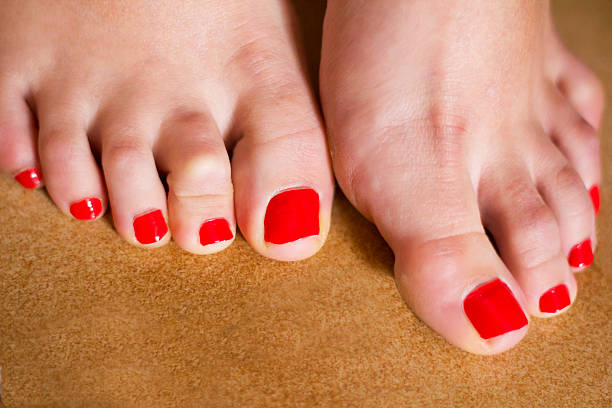 istock Female feet with red toenail 471756759