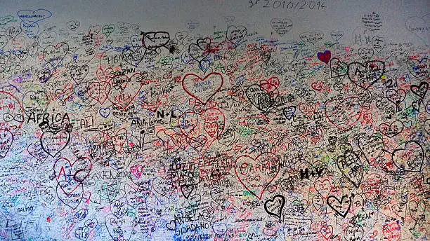 love wall of Giulietta house in Verona Italy, couples around the world comes here painting signature.