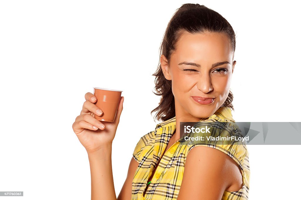 cup of coffee from the machine beautiful young smiling brunette holding her coffee from the machine and winks Coffee - Drink Stock Photo