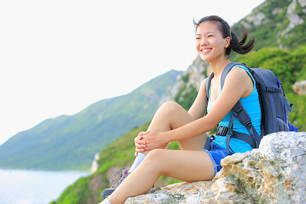 istock young woman hiker  sit mountain rock 471760537