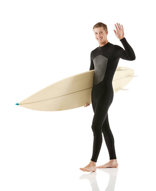 istock Surfer holding surfboard and waving hands 471760947