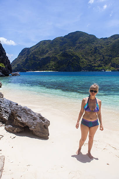 istock Woman on a perfect beach 471761249