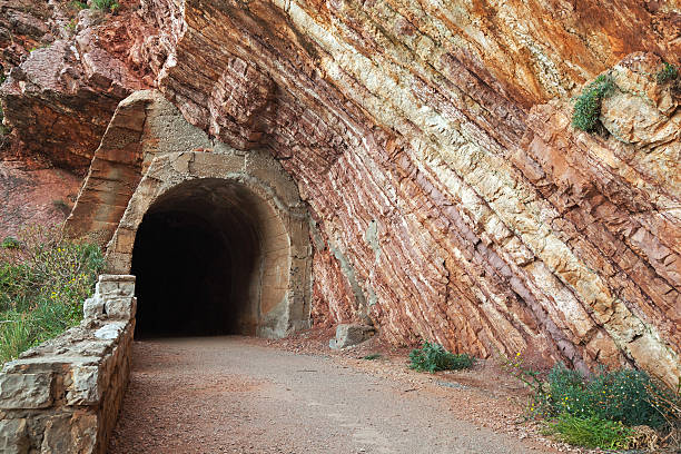 istock Old tunnel entrance in red rock 471761375