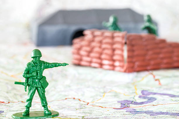istock Leadership concept with little green armed soldier toy 471761466