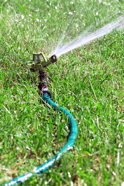istock Lawn sprinkler spraying water 471763747