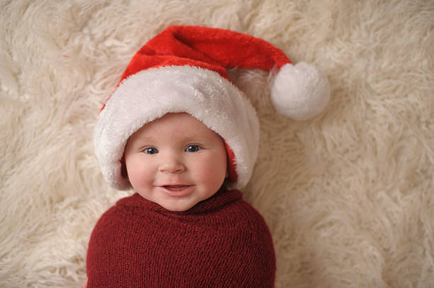 istock Swaddled Smiling Baby Boy Wearing Santa Hat 471763933