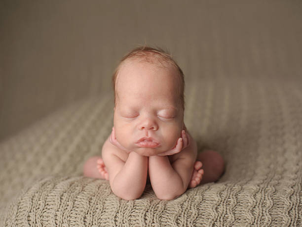 istock Preemie Newborn Boy Sleeping with his Head on Hands 471764079