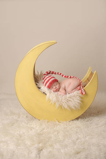 istock Preemie Newborn Sleeping Peacefully in Moon prop Wearing Hat 471764099