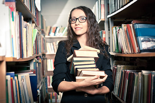 istock brunette woman at library 471764357