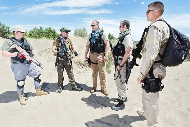 Photo of Military soldiers doing training exercises in desert location