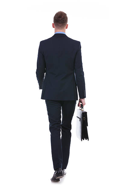 istock business man walks away with suitcase 471765015