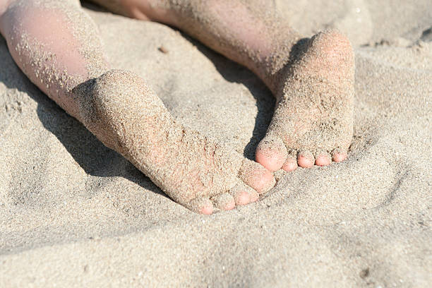 child's foot on the beach