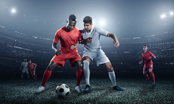 istock Soccer player kicking ball in stadium 471765410