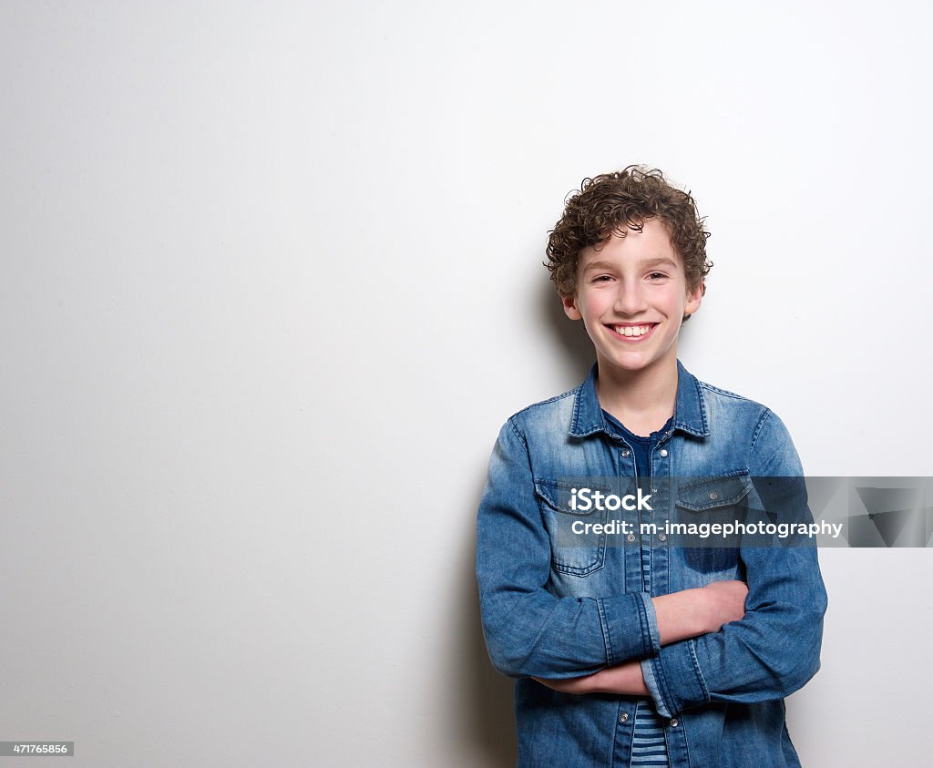 Cheerful little boy smiling with arms crossed Portrait of a cheerful little boy smiling with arms crossed on white background 10-11 Years Stock Photo