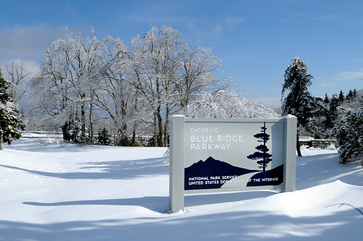 Winter scene of snow, ice and blue skies on Blue Ridge Parkway in Blue Ridge Mountains.