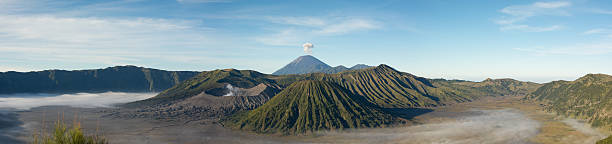 Bromo Volcano Panorama Panorama of the volcanos from Indonesia. Sumeru smoking on the top, Bromo on the left, and Batok on the middle of the photo. sumeru stock pictures, royalty-free photos & images