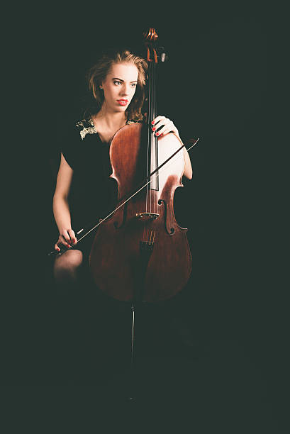 istock Pensive Lady Cellist Holding a Cello Instrument 471767094