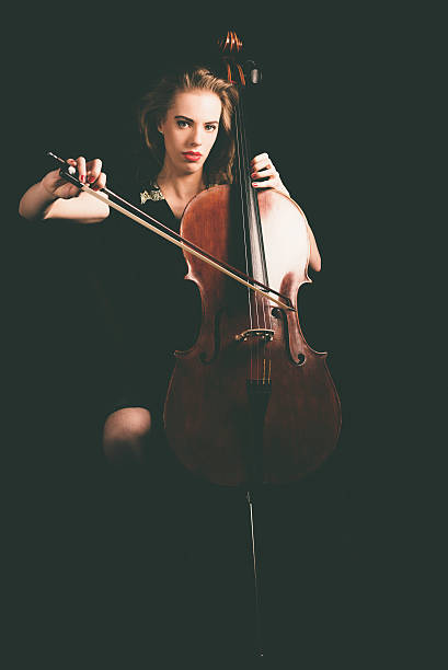 istock Woman Playing a Cello Instrument Looking at Camera 471767118
