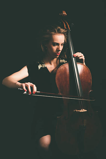 istock Young Female Cellist Playing Cello Instrument 471767130
