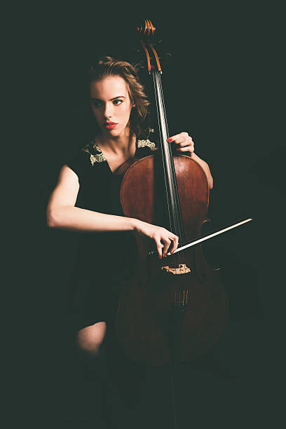 istock Pretty young woman playing the cello 471767134