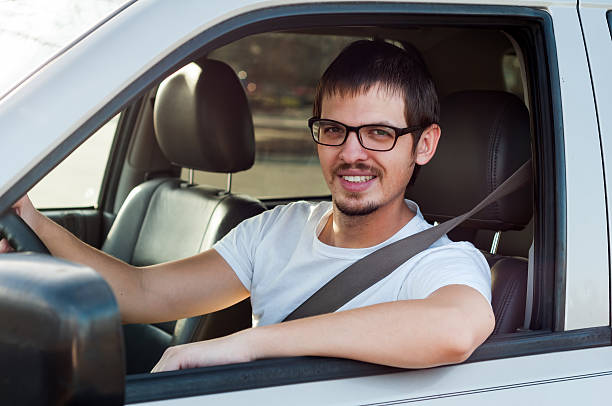 Male european good driver is smiling in his car stock photo
