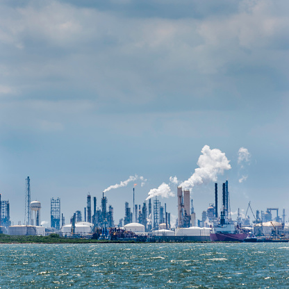 Atmospheric distortion blurs the view of the petrochemical oil processing refinery plant of the industrial skyline in Texas City, Texas, USA, on Galveston Bay and the Gulf of Mexico