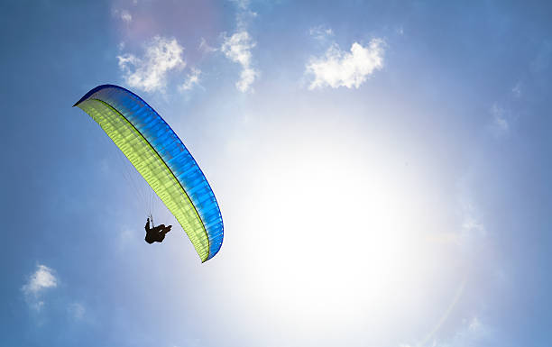 istock Paraglider hovers in a sunny blue sky 471768783