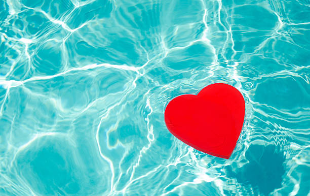 Heart shaped floating device in a pool stock photo